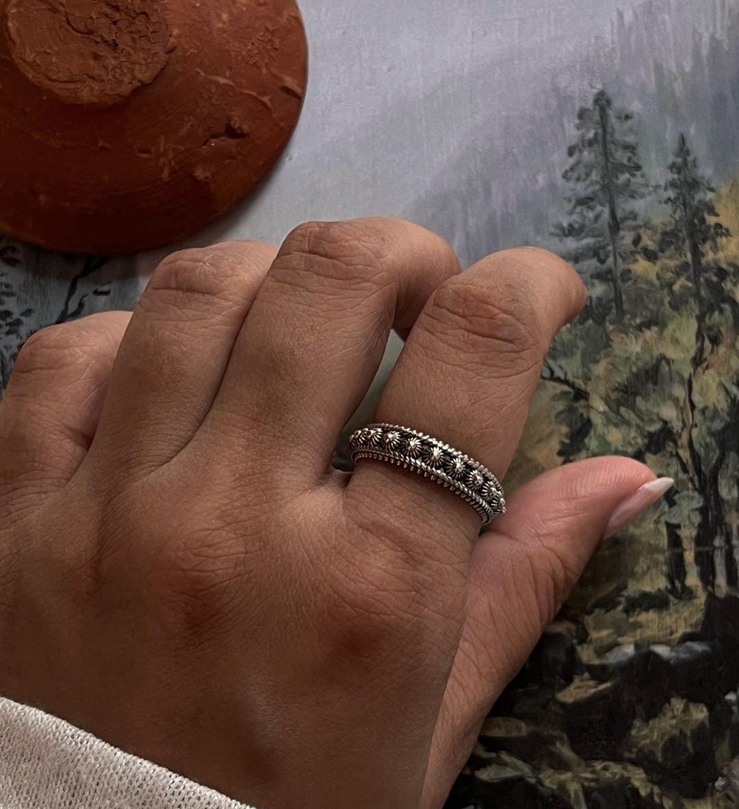 Balinese-style fixed size silver ring with intricate engraving.