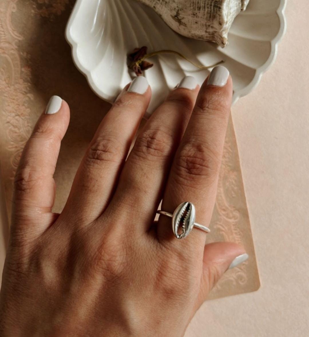 Simple and elegant silver ring with a unique cowrie seashell