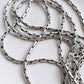 Intricate antique silver chain with unique patterns and texture.
