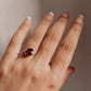 Sterling silver ring featuring two marquise-cut garnet stones