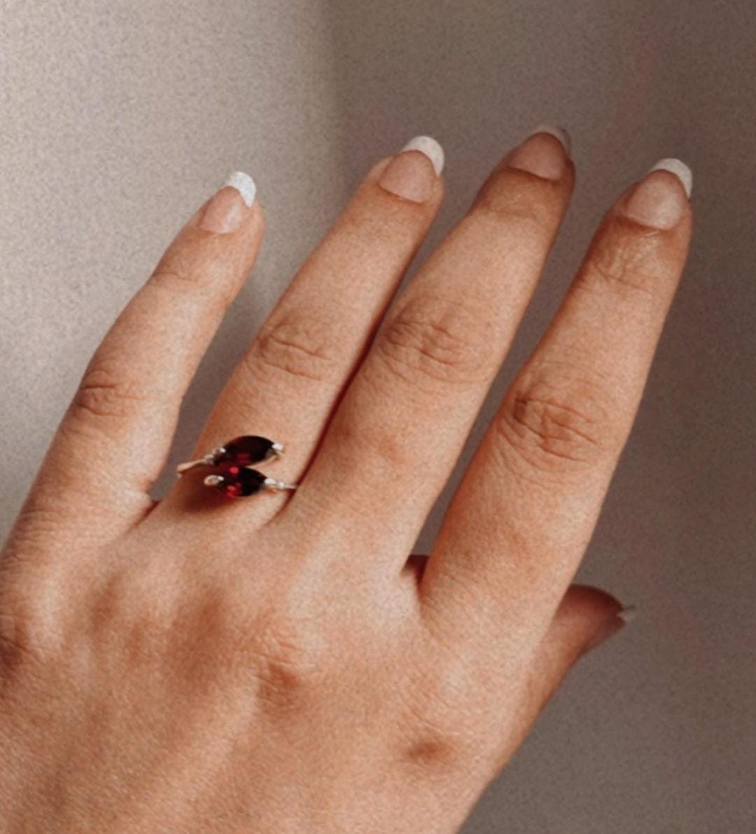 Sterling silver ring featuring two marquise-cut garnet stones