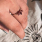 Garnet pear and round cut silver ring with three stones