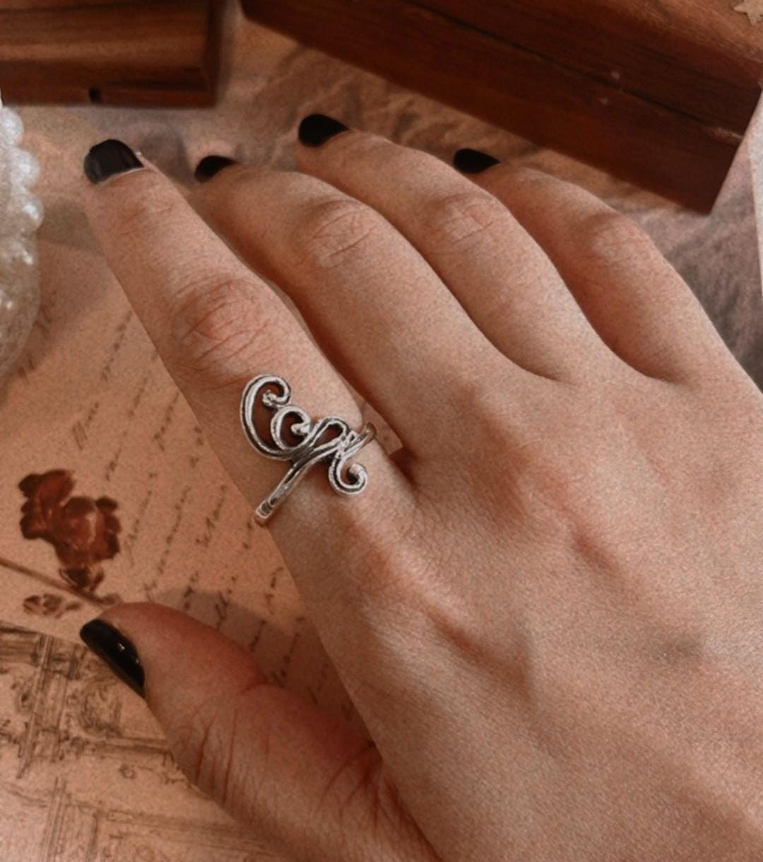 Handmade silver ring featuring spiral motif design