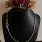 Vintage-inspired silver chain with an antique-patterned S-lock design.