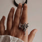 Sophisticated adjustable silver ring with a subtle angel accent.