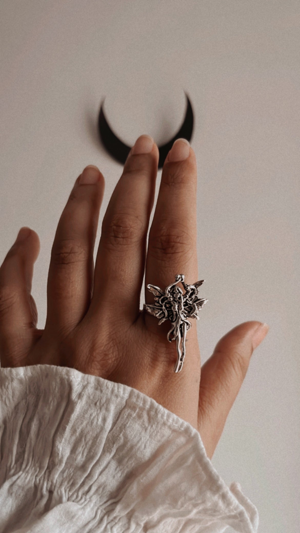 Sophisticated adjustable silver ring with a subtle angel accent.