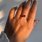 Garnet pear-shaped solitaire ring in a sleek silver setting