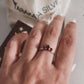 Silver ring with three garnet stones in pear and round cuts