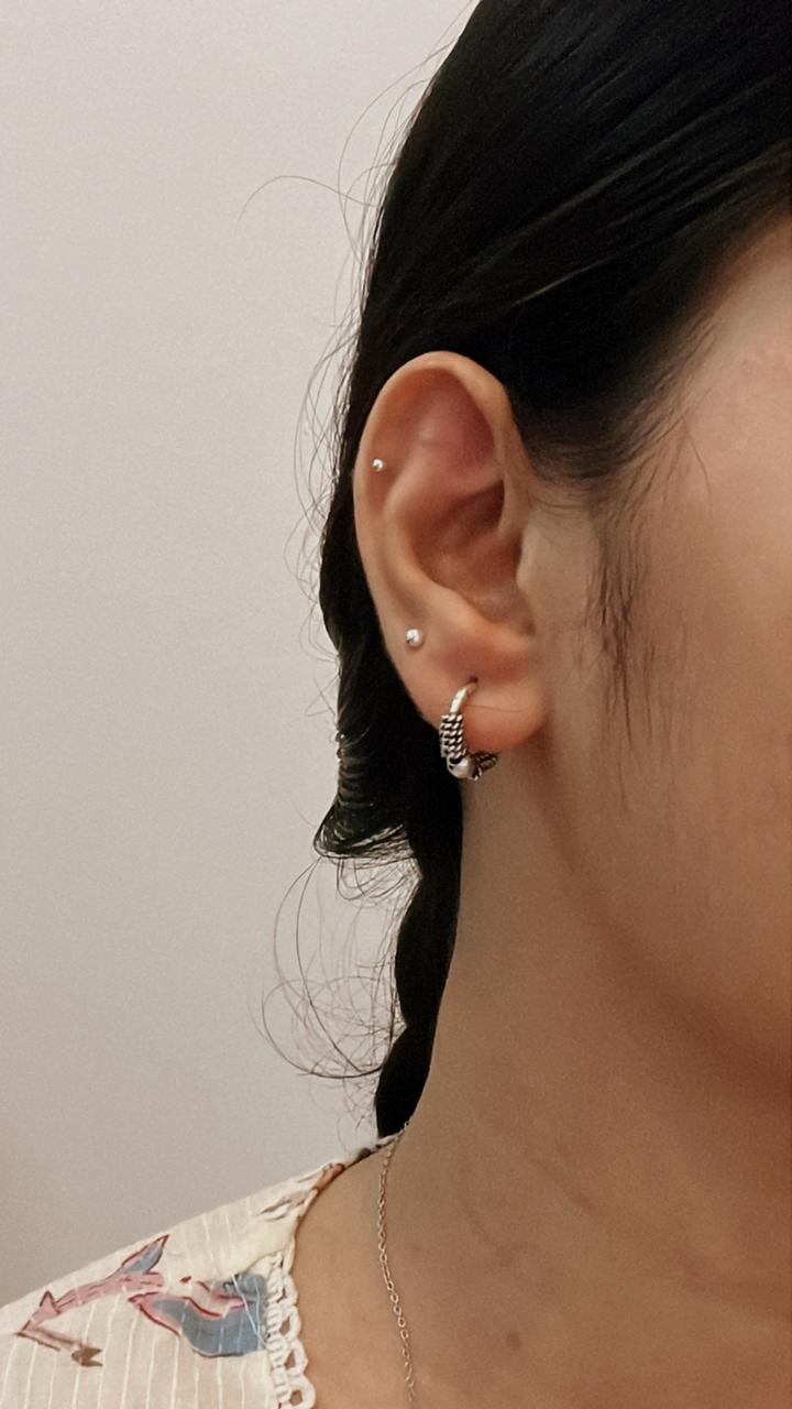Timeless antique silver hoop earrings with detailed pattern.