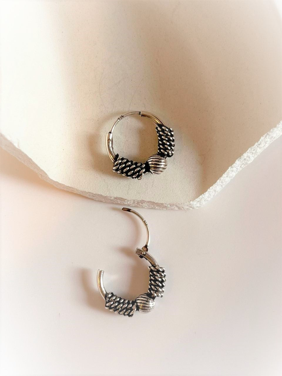 Vintage-style silver hoops with a unique antique design.