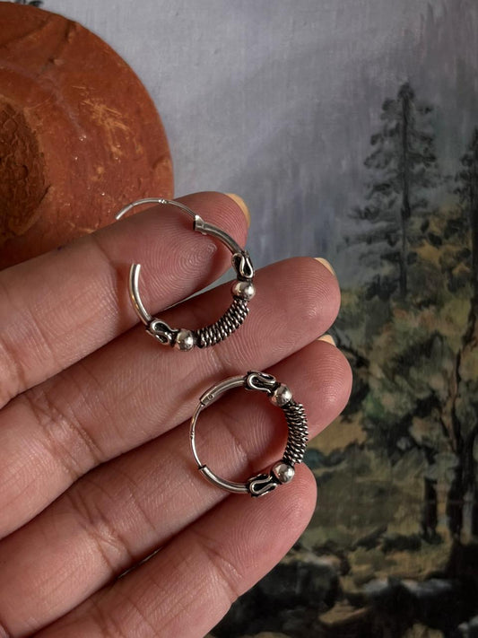 Vintage-style silver hoops featuring intricate design 2.