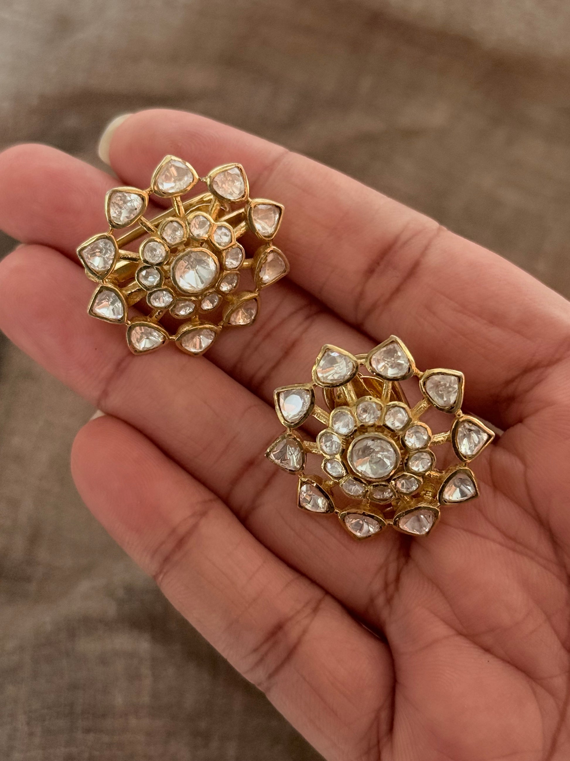 925 Sterling Silver Gold Plated Antique Moissanite Polki Earrings held in hand, showcasing floral design and sparkling stones.