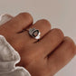 Silver ring featuring a divine lotus design and garnet stone