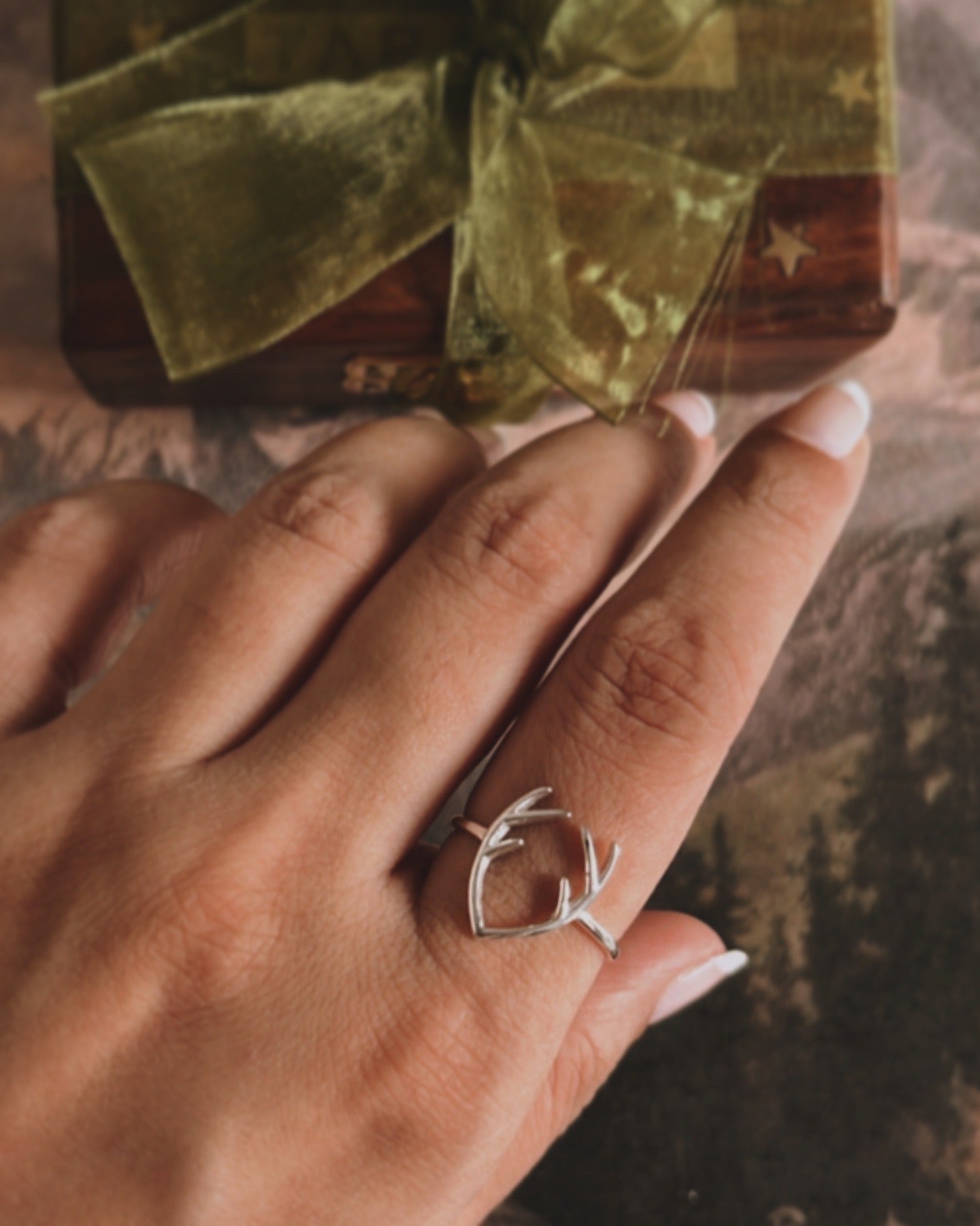 Handcrafted silver ring with a unique antler design.
