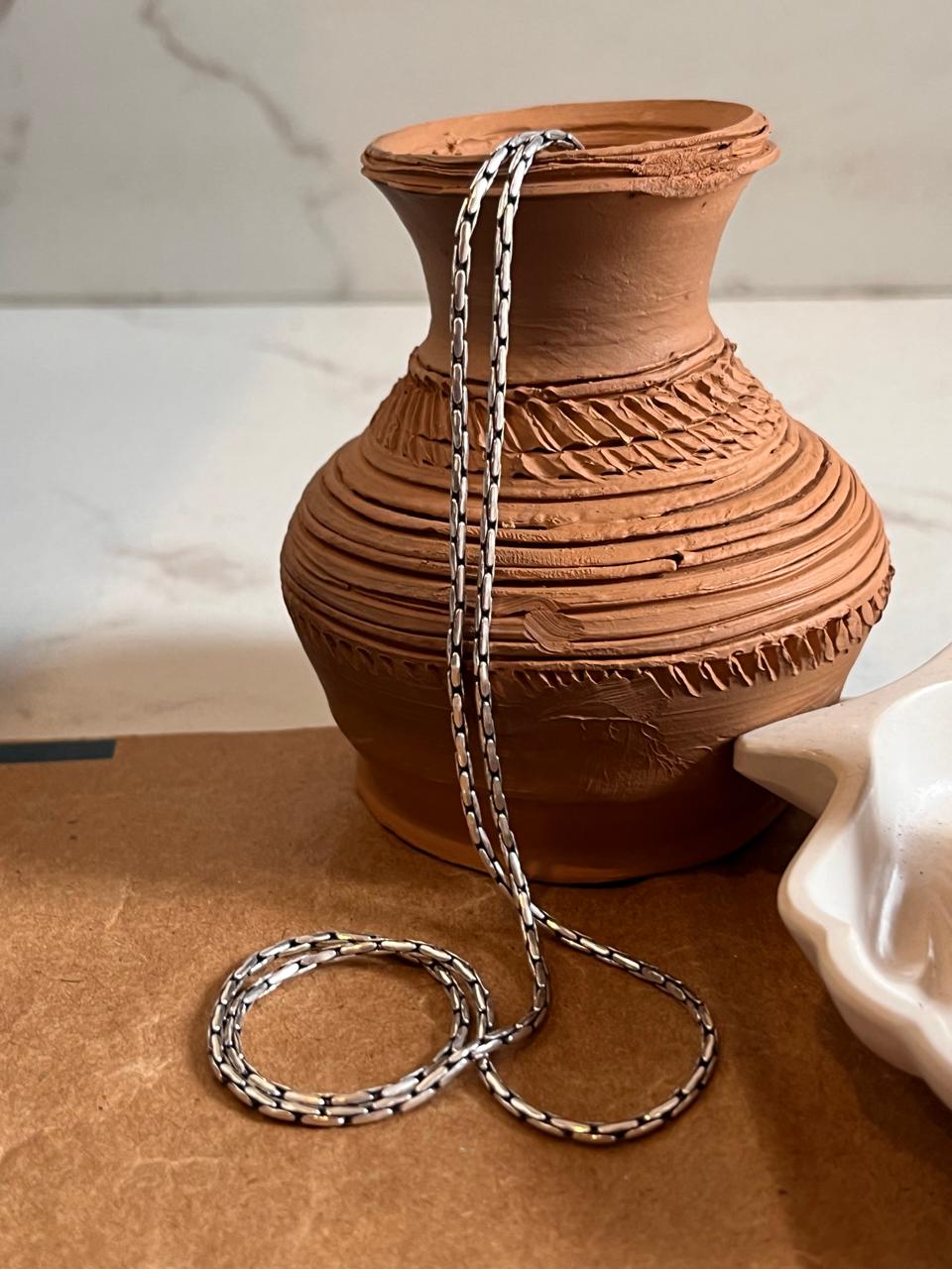 Sophisticated sterling silver chain with a detailed antique pattern.