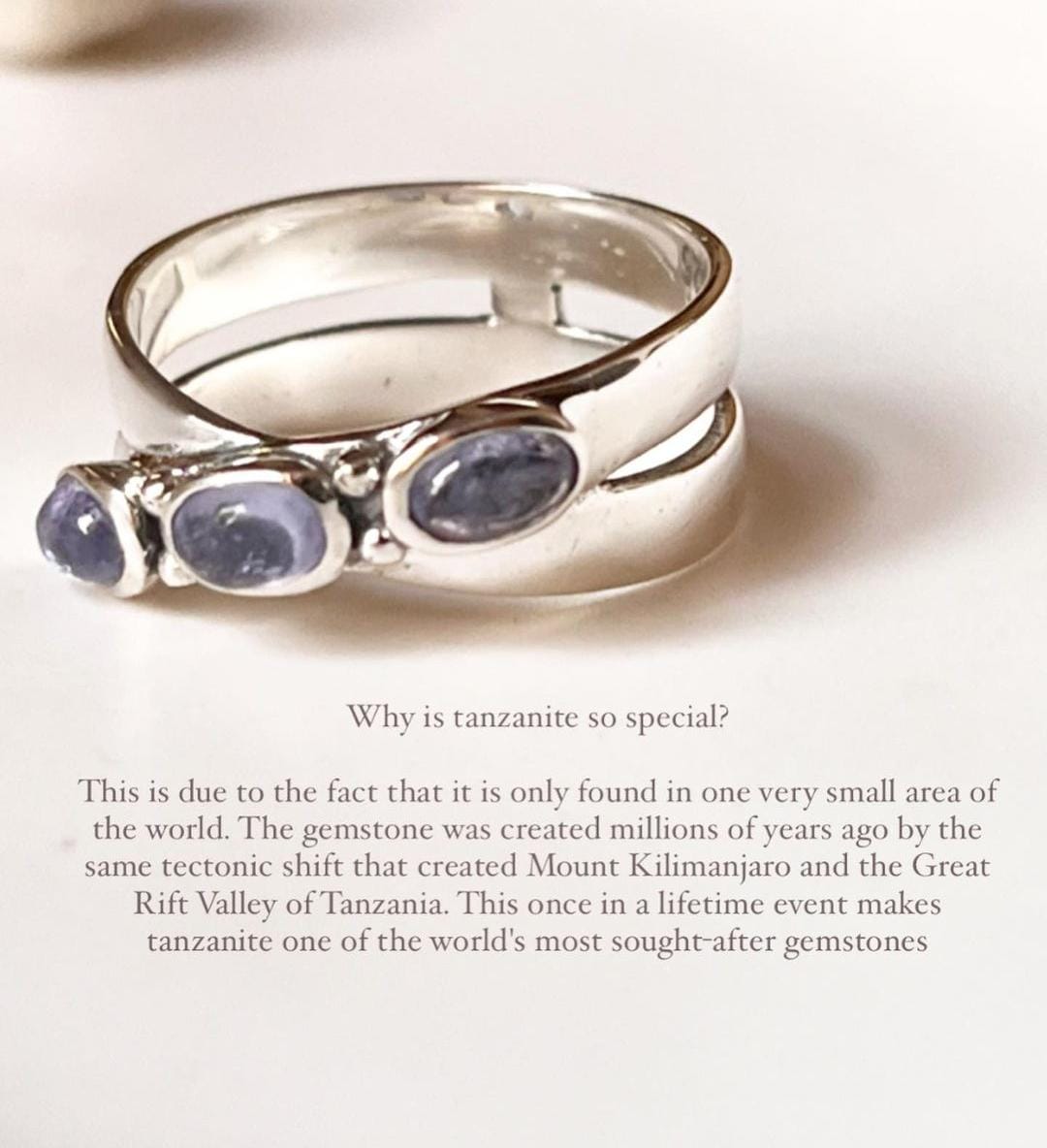 Elegant tanzanite cross band silver ring