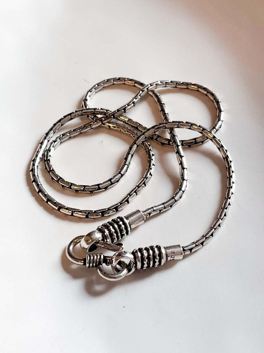 Antique patterned S-lock silver chain with intricate detailing.