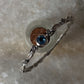 Decorative forest-inspired bangle with blue topaz in silver