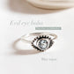 Charming evil eye boho silver ring with vibrant blue topaz centerpiece