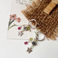Sterling silver Italian hoops with flower, butterfly, and gemstone charms  