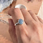 Charming oval aquamarine silver ring with natural stone setting.