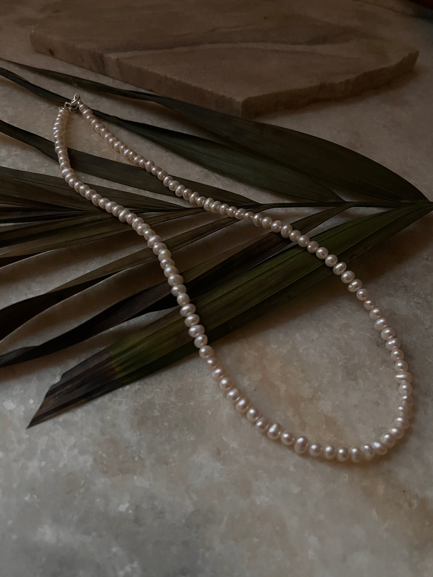 Handcrafted freshwater pearls necklace with silver lock detail