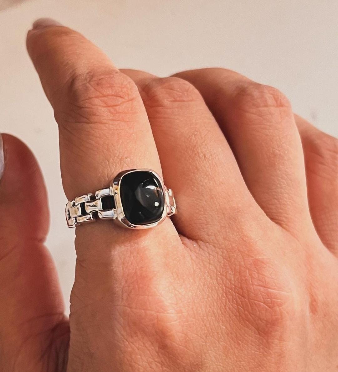 Sophisticated black onyx Cuban link band ring with polished silver finish.