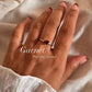 Solitaire silver ring featuring a striking pear-cut garnet stone