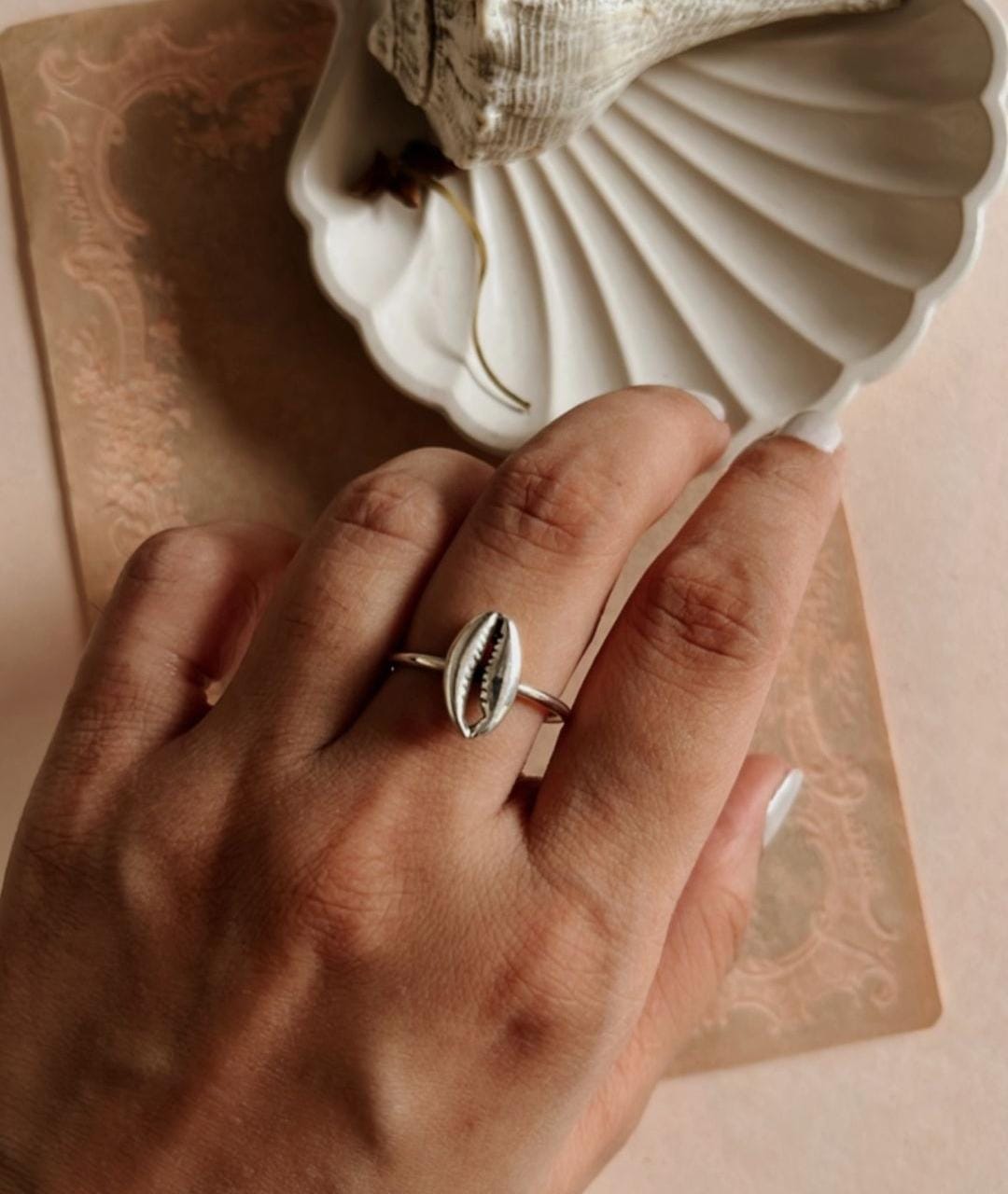 Sculpted silver ring with a cowrie seashell for a natural, coastal look