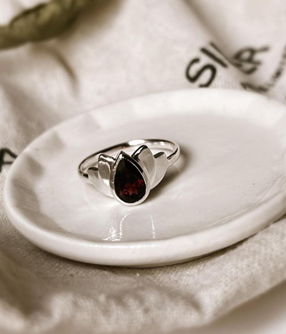 Garnet adorned divine lotus silver ring with intricate details