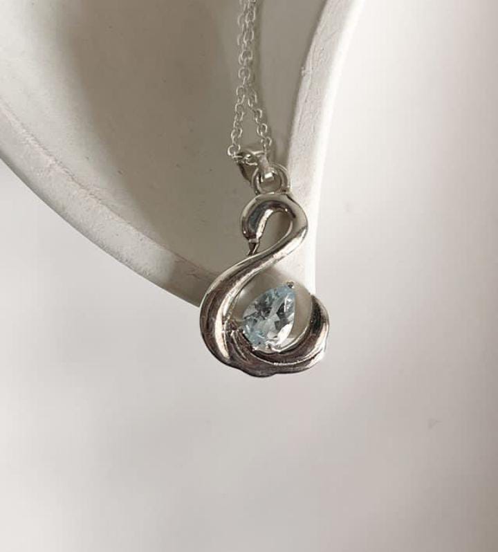 Delicate Blue Topaz Silver Pendant Featuring Swan Design