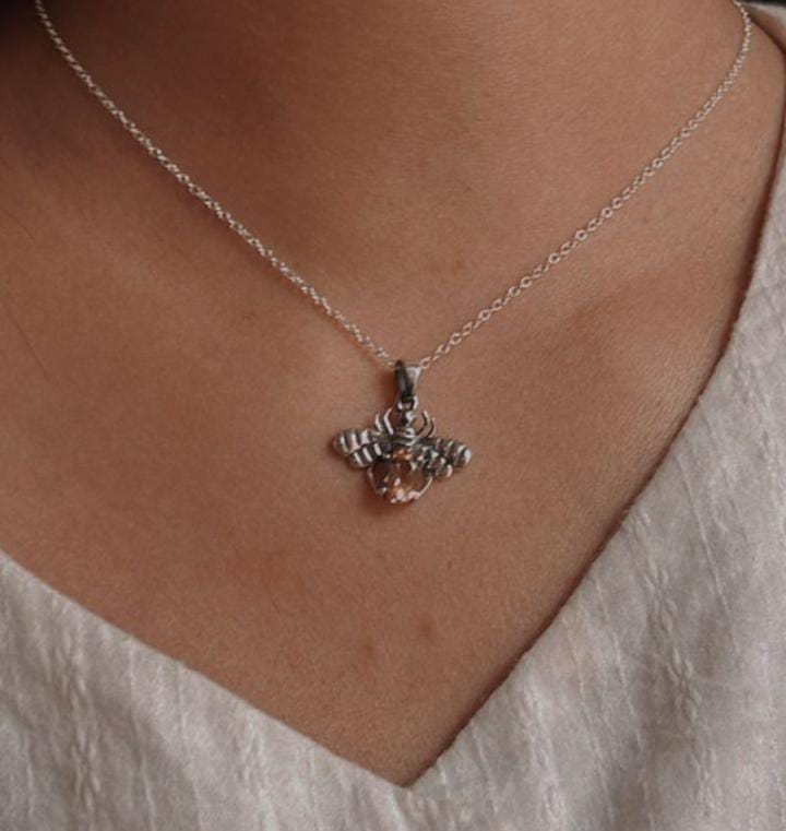 Elegant silver pendant featuring a bee motif and citrine gemstone.