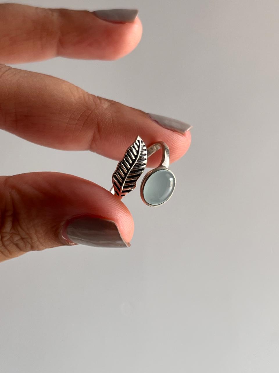 Elegant aqua chalcedony silver ring with a feather-inspired adjustable band.