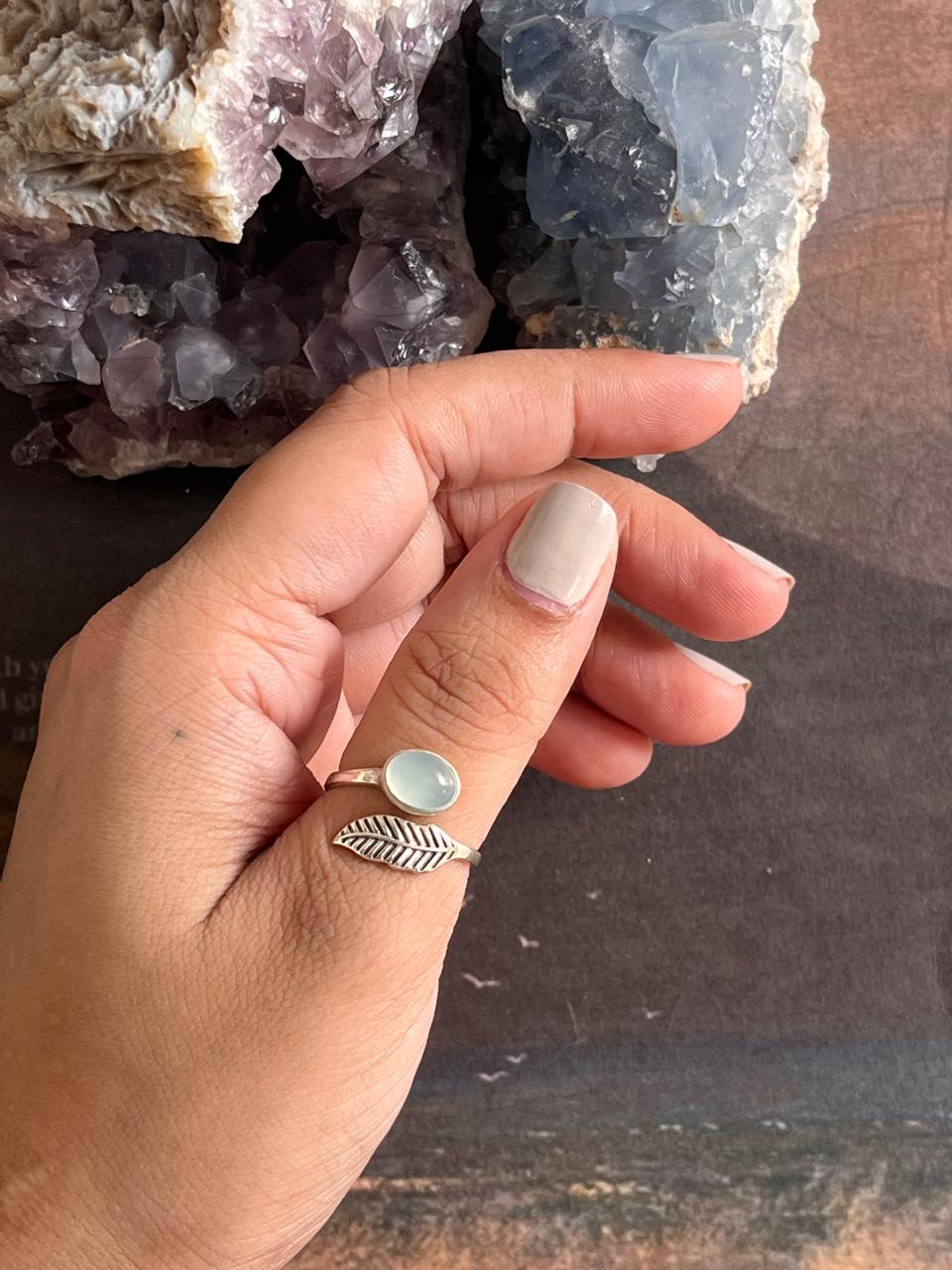 Handcrafted adjustable silver ring with a feather motif and aqua chalcedony.