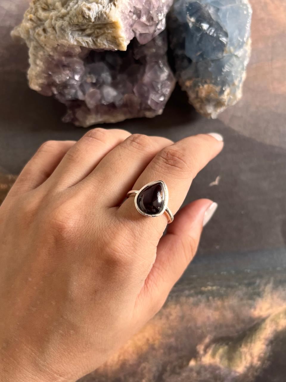 Large silver ring with a pear-cut garnet gemstone