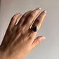 Big silver ring featuring a stunning pear-cut garnet stone