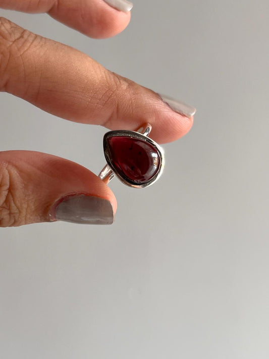 Bold garnet pear-shaped silver ring with a plain design