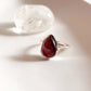 Garnet pear cut ring in a sleek plain silver design