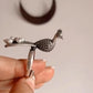 Elegant adjustable silver 925 ring featuring a peacock and freshwater pearl accent.