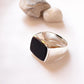 Elegant black onyx signet ring with a faceted, geometric cut.