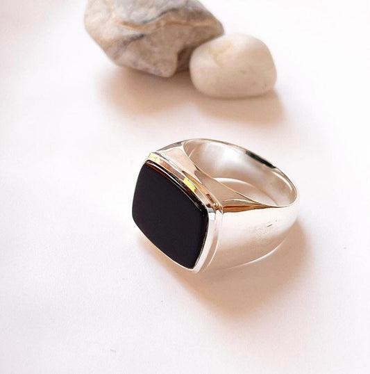Elegant black onyx signet ring with a faceted, geometric cut.