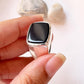 Timeless big faceted signet ring featuring a large black onyx stone.