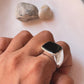 Sleek big black onyx signet ring with a faceted finish in sterling silver.