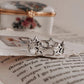 Charming silver ring with round band and star motifs