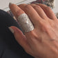 Bohemian-style handcrafted silver ring with a detailed mandala tribal motif.