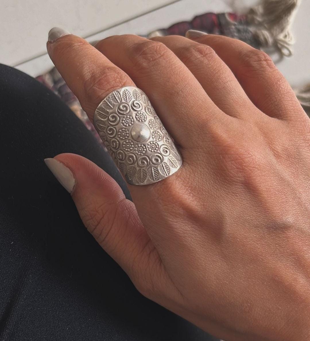 Bohemian-style handcrafted silver ring with a detailed mandala tribal motif.