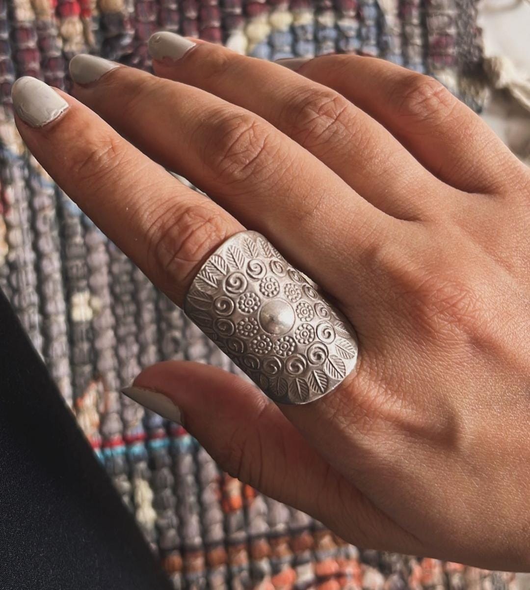 Intricate handcrafted bohemian ring with a tribal mandala pattern in silver.