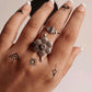 Bohemian-style adjustable silver ring with an antique flower design.