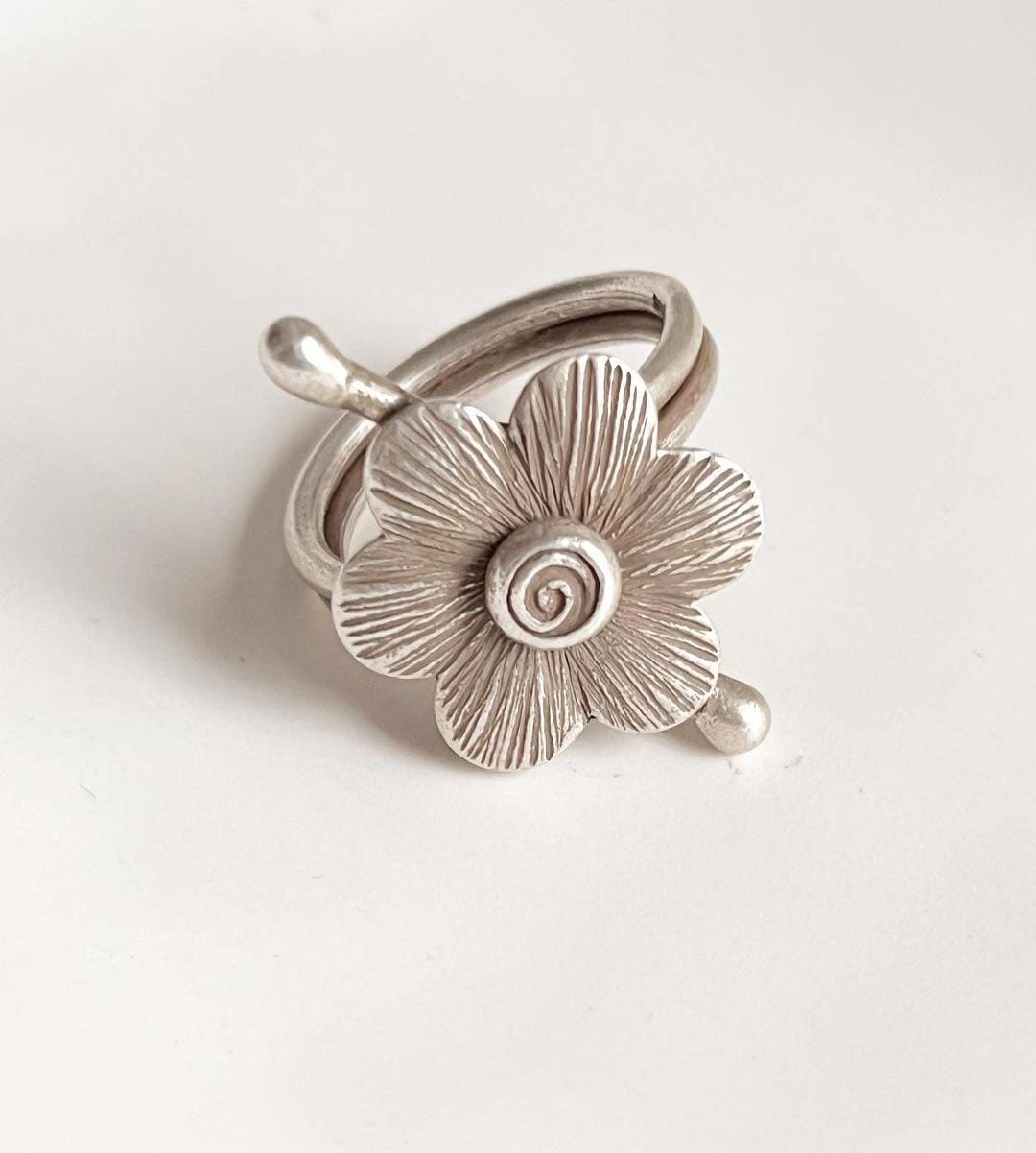 Unique handcrafted adjustable silver ring with a bohemian flower design.