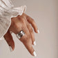Sophisticated feather wrap adjustable silver ring with graceful, flowing design